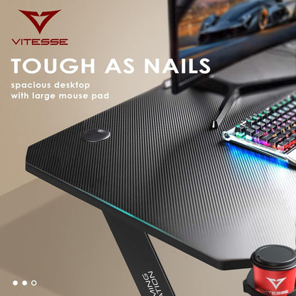 63 Inch Ergonomic Gaming Desk, Z Shaped Office PC Computer Desk with Large Mouse Pad, Gamer Tables Pro with USB Gaming Handle Rack, Stand Cup Holder and Headphone Hook, Black